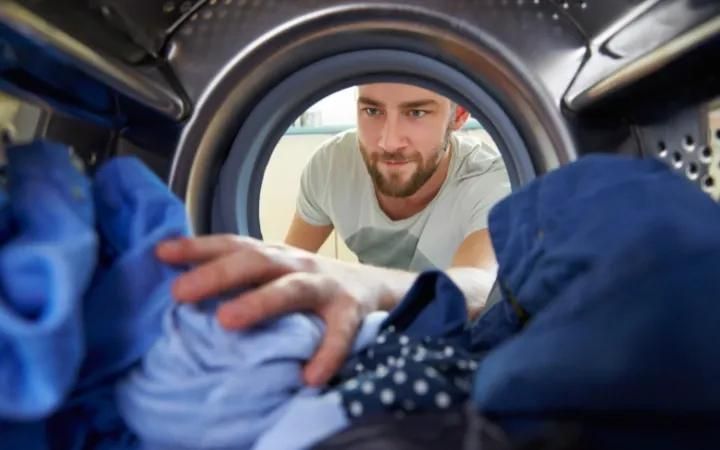 homme utilisant une machine à laver