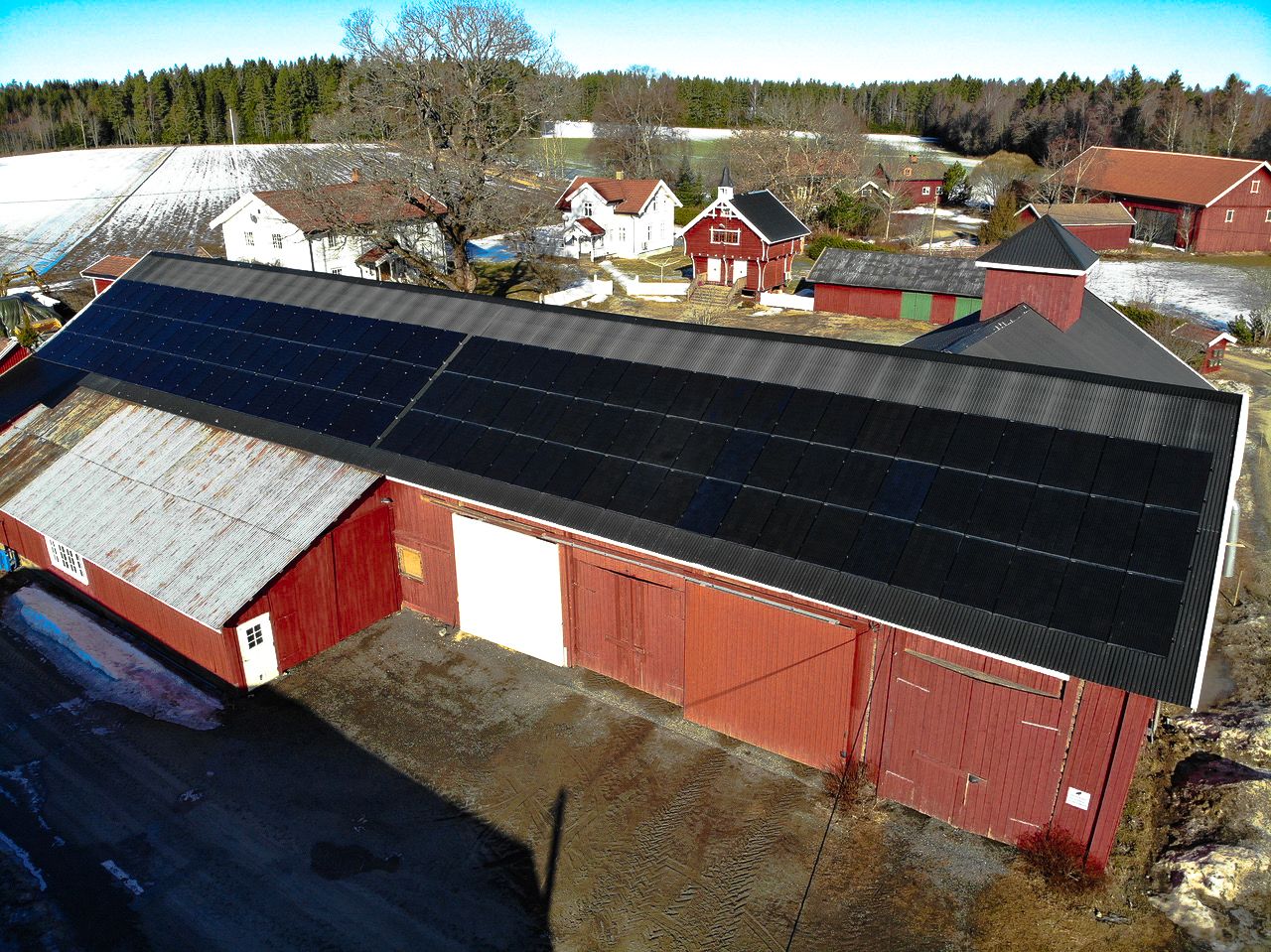 en låve med solcellepaneler ovenfra